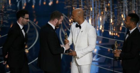 Singers John Legend (R) and Common (2nd R) present Sam Smith (2nd L) and Jimmy Napes